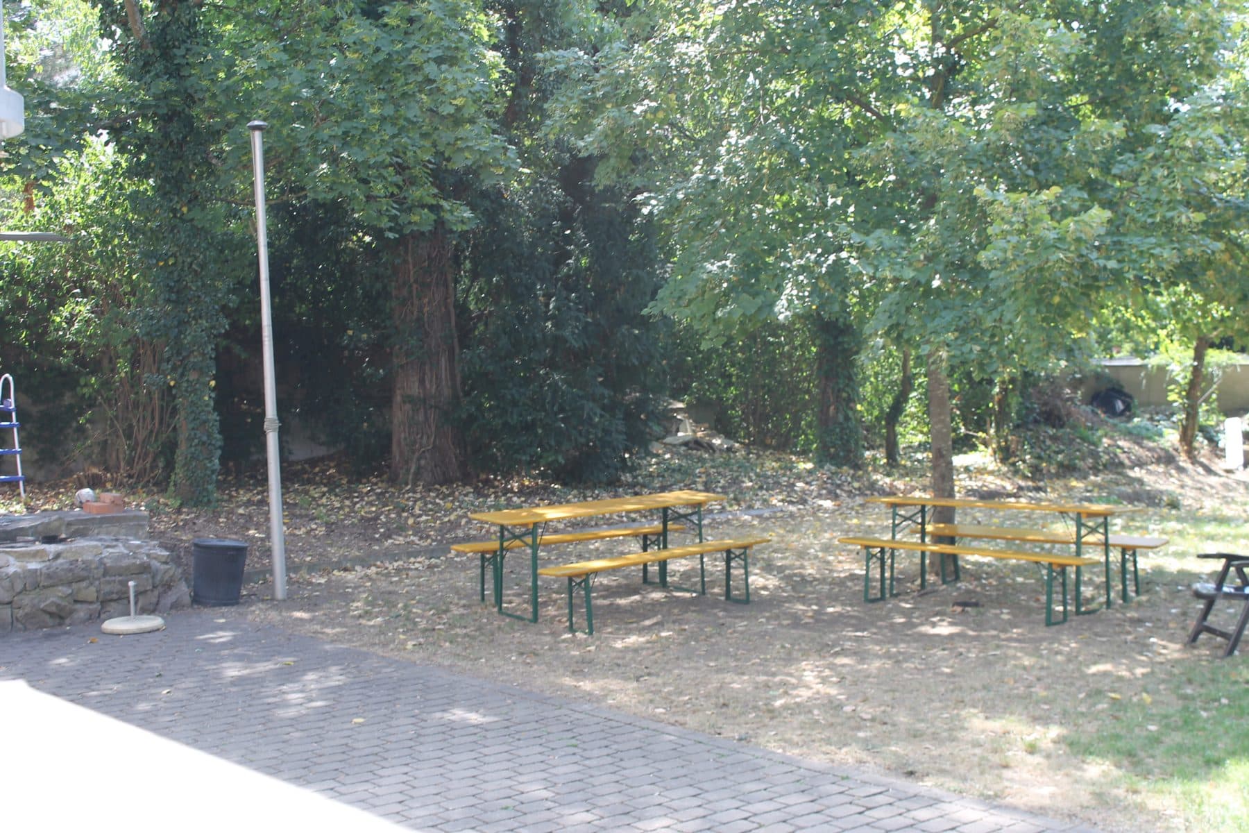 Garten mit Biertischen unter Bäumen